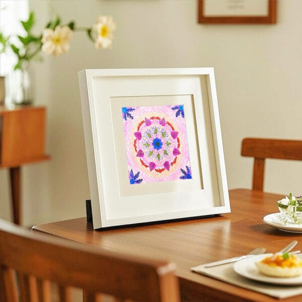 Framed mandala art with pressed flowers displayed on a wooden table for calm home decor