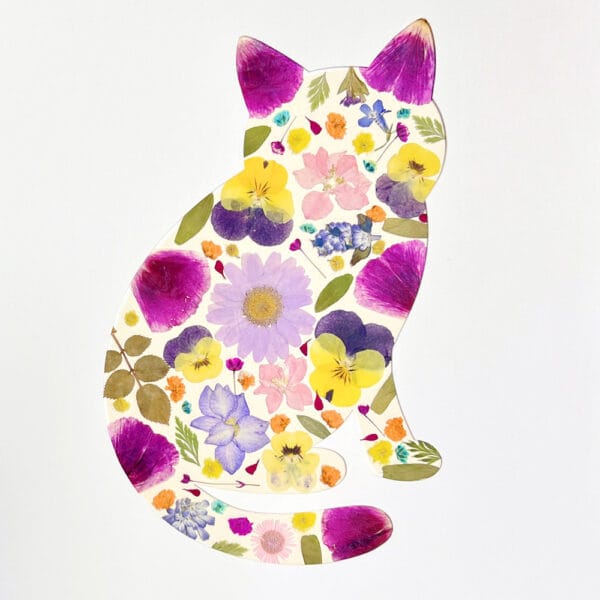 cat-shaped floral collage made with colorful pressed flowers as a playful pressed flower art idea