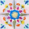 Star-shaped floral mandala made with pressed flower kit, featuring layered petals and fern details