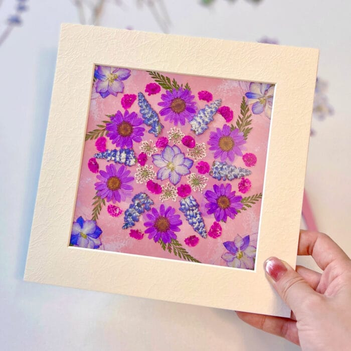 Holding a handmade mandala artwork created with the serenity bloom pressed flower kit – calm in your hands