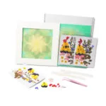 Serenity Light pressed flower kit with yellow and green floral materials arranged in a radiant mandala collage for mindful DIY art.