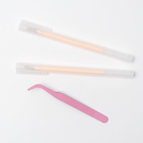 Quick-dry glue pens and curved tweezers used for arranging pressed flower materials in mandala art