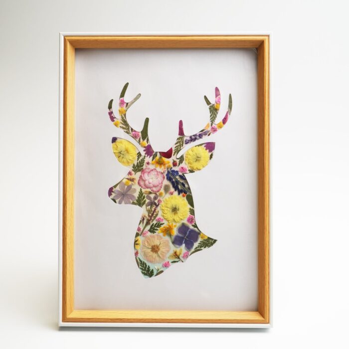 Framed deer pressed flower collage in warm yellow and pink tones, created with petal & still diy kit.