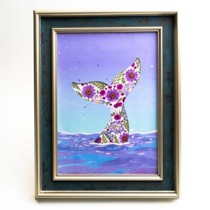 Framed pressed flower whale tail art with purple ocean waves and soft starry sky background.