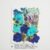 A blue and teal pressed flower sheet from the Petal & Still kit, featuring hydrangeas, nigella, larkspur, and naturally varied botanicals. Each set is uniquely color-coordinated.