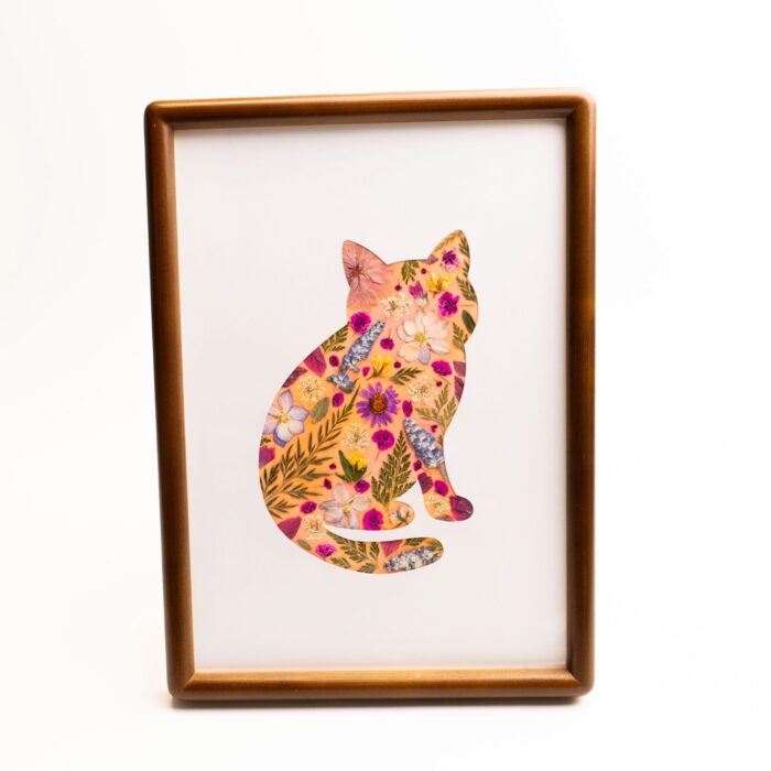 A botanical pressed flower cat collage in a walnut-style wooden frame – handmade art from the curious edition of the pressed flower kit.