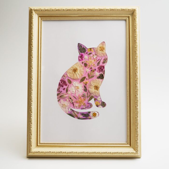 Cat-shaped pressed flower collage displayed in an ornate golden frame, part of the pressed flower kit collection for mindful creativity.