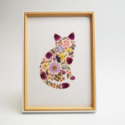 Pressed Flower Kit cat artwork in a natural wood frame – a floral silhouette collage shaped like a sitting cat, made with real dried flowers.