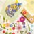 Pressed flower kit cat gentle finished design with blue, yellow, and white pressed flowers.