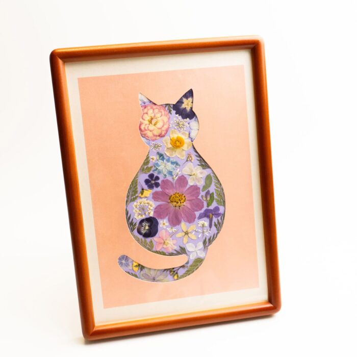 Finished floral cat artwork made with the cat pressed flower kit — cozy, featuring pastel petals on a warm background, framed for display.
