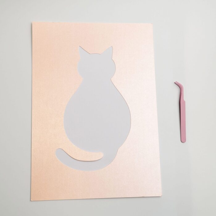 Pre-cut a4 cat template and pink tweezer from the cozy pressed flower kit, designed for easy petal placement.