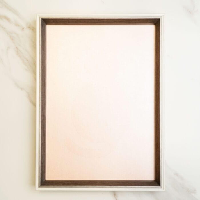 Front view of a wooden frame with a pastel pink background, ideal for displaying pressed flower collage art.