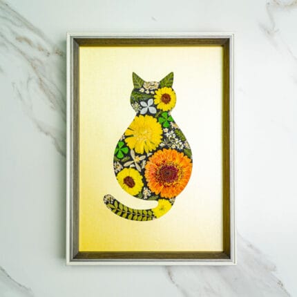 Pressed flower kit cat silhouette with yellow and orange dried flowers on gold background