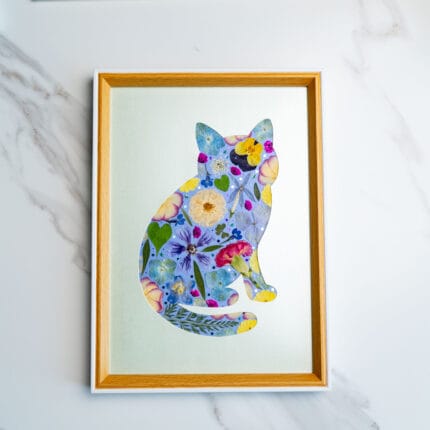 Pressed flower cat design featuring soft blue, yellow, and pink blooms on a pale green background.