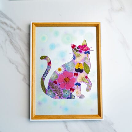 Playful pressed flower cat looking upward, filled with colorful pink and purple blooms on a dotted pastel background.
