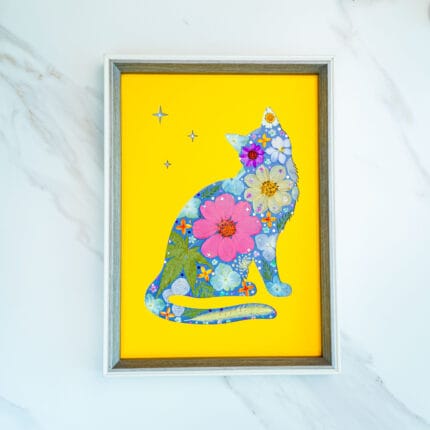 Pressed flower cat artwork of a dreamy silhouette looking at stars, colorful flowers on bright yellow background