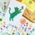 Template card of playful cat silhouette reaching for butterfly, DIY pressed flower kit with natural flowers
