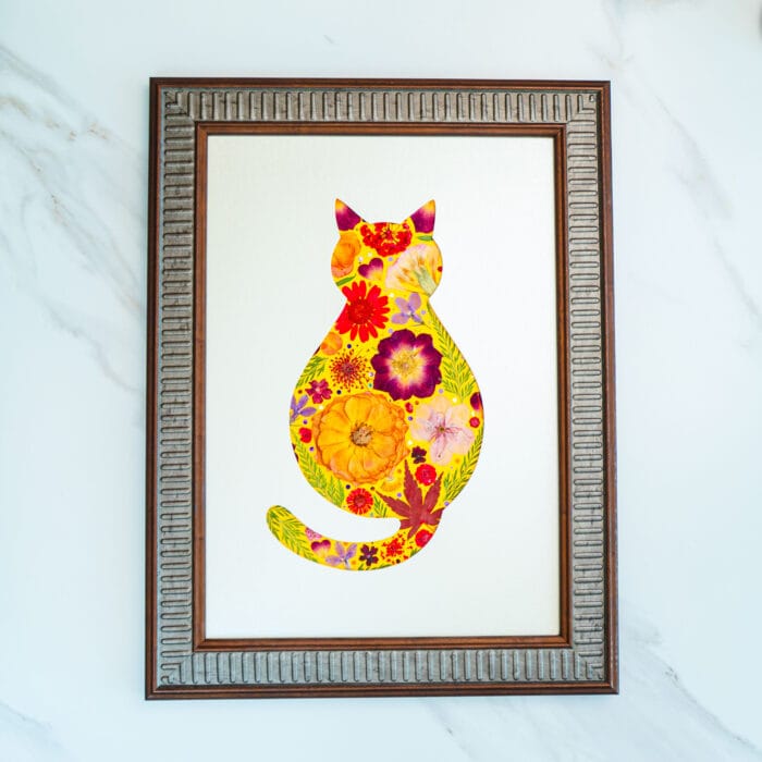 Pressed flower cat artwork with warm sunny tones of yellow and orange, framed handmade floral design