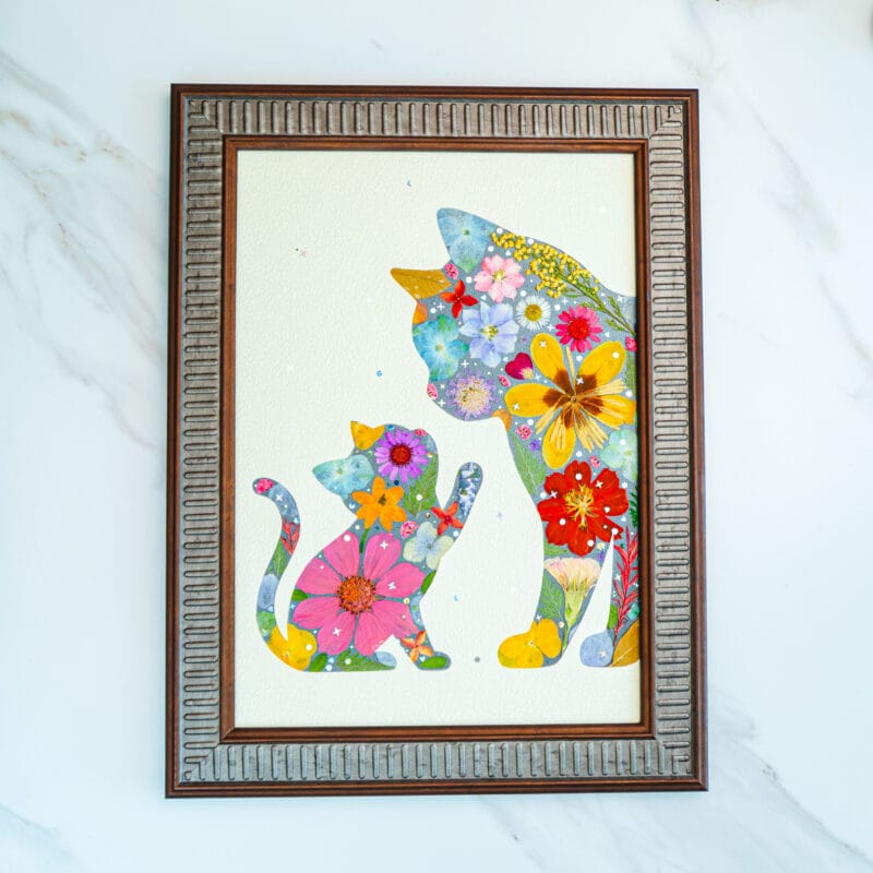 Pressed flower cat artwork of a mother cat and kitten, tender floral design symbolizing love and care