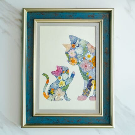Pressed flower art of a mother cat and kitten silhouette decorated with pastel flowers in a blue frame