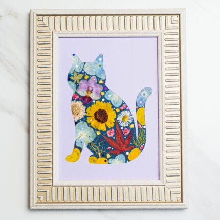 Pressed flower cat silhouette on lavender background, decorated with yellow, purple, and sunflower petals.
