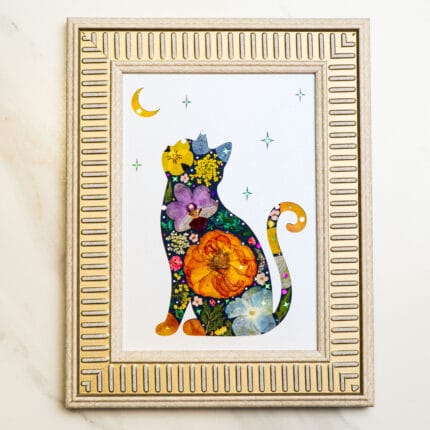 Pressed flower cat looking up at the moon and stars, framed in silver with vibrant floral details.