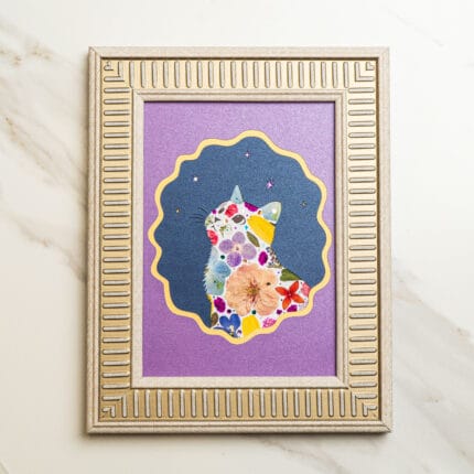 Pressed flower kit cat artwork “Starry Bloom” finished design with purple background and silver frame.